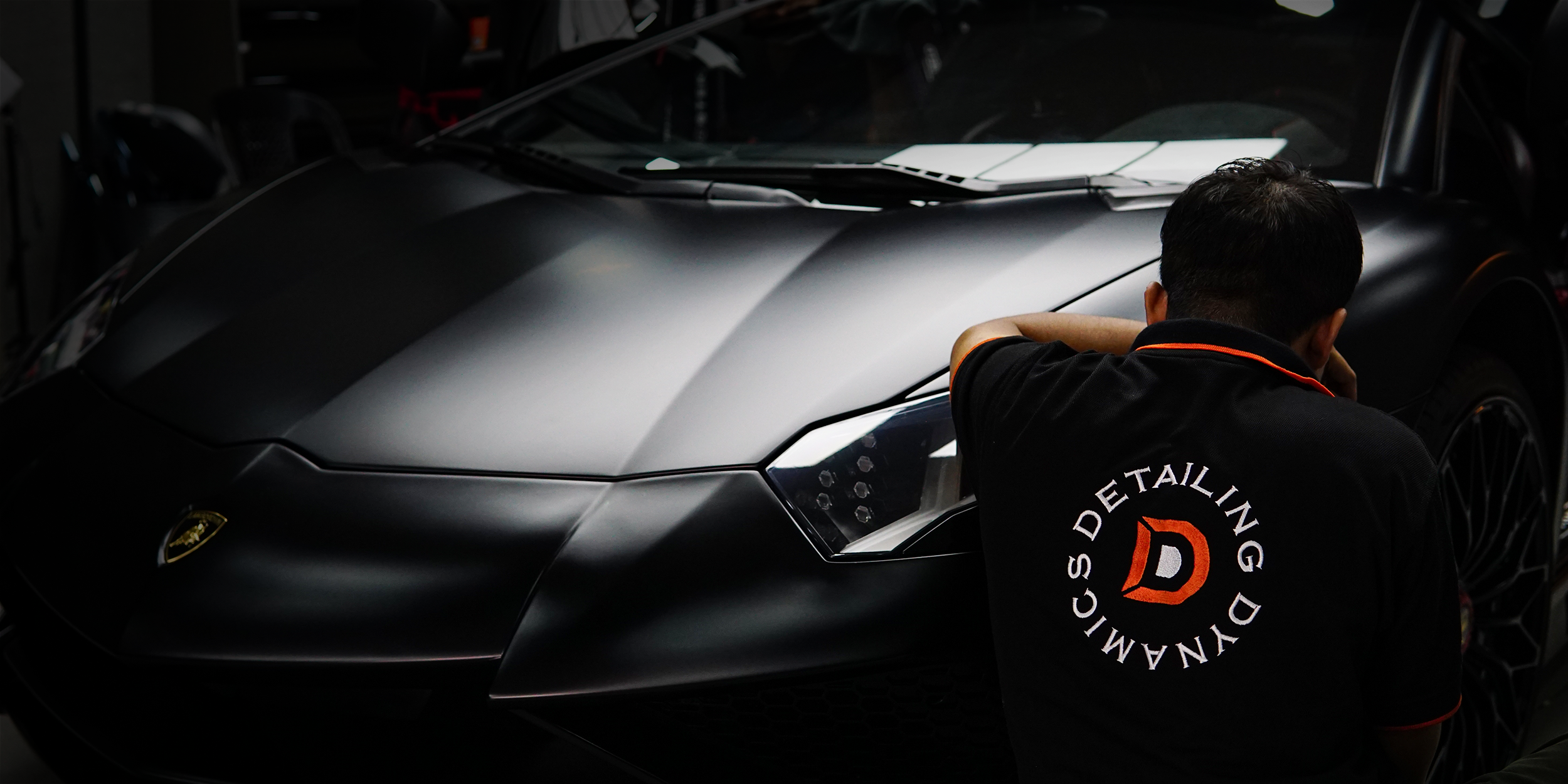 Detailing Dynamics technician working on a Lamborghini, Dubai Investment Park 2
